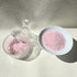 Rose quartz care essentials detail - bracelet resting on rose quartz chips for energy purification